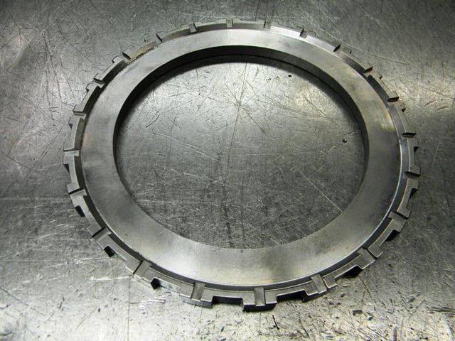 Here’s the billet steel intermediate pressure plate. Hughes uses a special pressure plate that’s thinner than conventional OEM TH400 cast iron pressure plates that allows them to fit five frictions and steels in the intermediate clutch pack compared to the conventional three or four. The billet steel constructions also reduces flex.