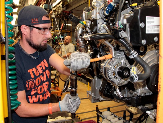 Jared Omell makes final touches to an EcoDiesel engine prior to