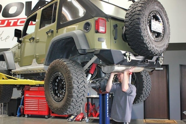Sgt. Rocker was in need of a new cat-back system, but first the factory unit had to be wrangled out from underneath the rear end of the Jeep.