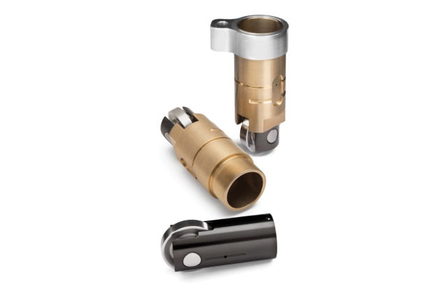 The Jesel Cartridge roller lifter. This is a stand-alone roller lifter pair that contains the lifters and bronze bushings and can be installed or removed in an aftermarket block with a single retaining bolt or stud. It is limited in application to those aftermarket and billet blocks that can accept the assembly's 1.312-inch outer diameter. Jesel’s Cartridge lifter is big—the lifter body is a full inch in diameter and the wheel measures 1.220-inches. Channels machined into the lifter bushing guide the wheel and maintain alignment with the camshaft lobe. Advantages include a huge 1.220-inch wheel that turns slower for less friction. It reduces the pressure angle against the lifter and it is easier to clean a block and any debris that might get trapped between the lifter bushings and the lifter bores. And, should you encounter a problem with a lifter or cam lobe, the lifter assembly (cartridge) can be easily changed at the track by removing a single bolt or nut (if studded in place) and replacing the cartridge. The special bronze bushing is pinned to the billet aluminum retainer that is secured in the block by a single bolt or stud.