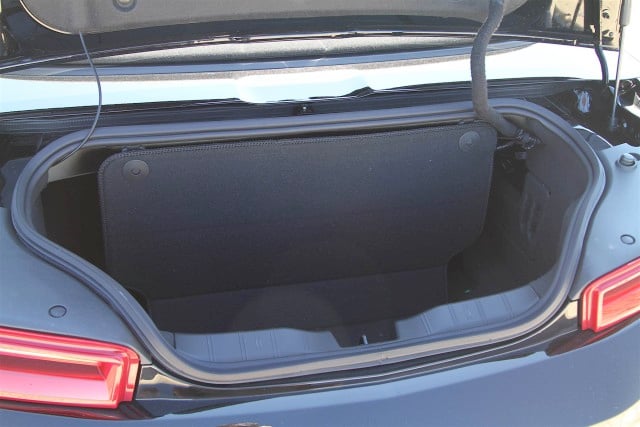 One obvious caveat with any convertible is that you'll be giving up trunk space when you put the top down. Divider in place, the Camaro's trunk only retains about the same capacity as an airliner overhead bin. Pop the divider loose, though (and remember not to put the top down!) and the trunk's full capacity is similar to the coupe, with what you can carry limited primarily by the small size of the trunk opening. 