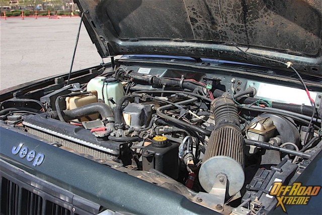 Although some of components were interchangeable between the AMC 258 cubic inch six-cylinder and the 2.5-liter four pot, the latter was not a cut down version of the big six. The 2.5-liter seen here has a shorter stroke and larger bore,  the valves are larger and the pistons are unique to the four cylinder. AMC/Chrysler engineer Roy Lunn explained in an interview for a book on the history of Jeeps that they wanted as much displacement as possible within the confines of bore centers of the tooling for power and torque, and the only parameter they could influence substantially was stroke. Accordingly, they picked the largest bore and stroke in order to get 2.5 liters out of it.