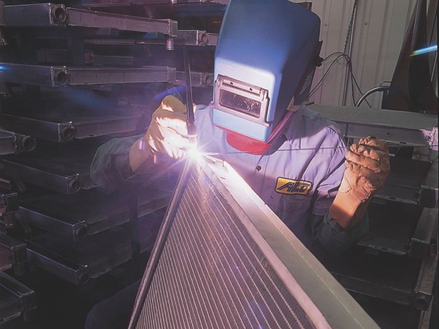 An AFCO staffer welding a radiator during the assembly process. AFCO offers a wide variety of sizes and layouts, and they can also build a radiator to your custom specs. Unlike many radiator manufacturers, AFCO doesn't jack up the prices for custom built designs, helping eliminate the need for customers to modify their product and potentially shorten its lifespan.