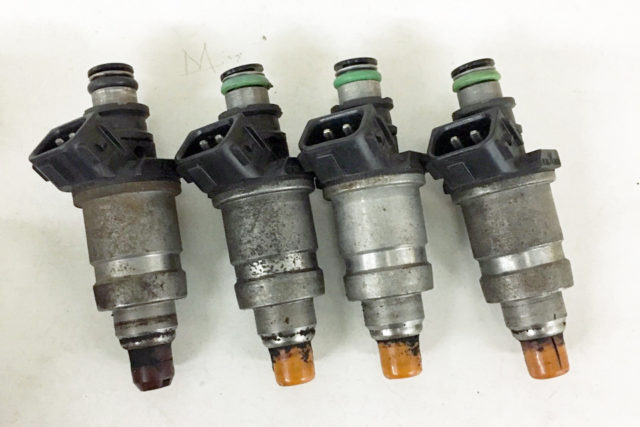 A set of injectors for an Acura Integra. This photo was taken prior to the cleaning service.