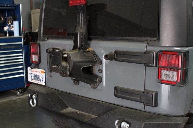The factory spare tire carrier serves the purpose fora factory vehicle. It is not built to survive the off-road lifestyle with a larger tire on it.