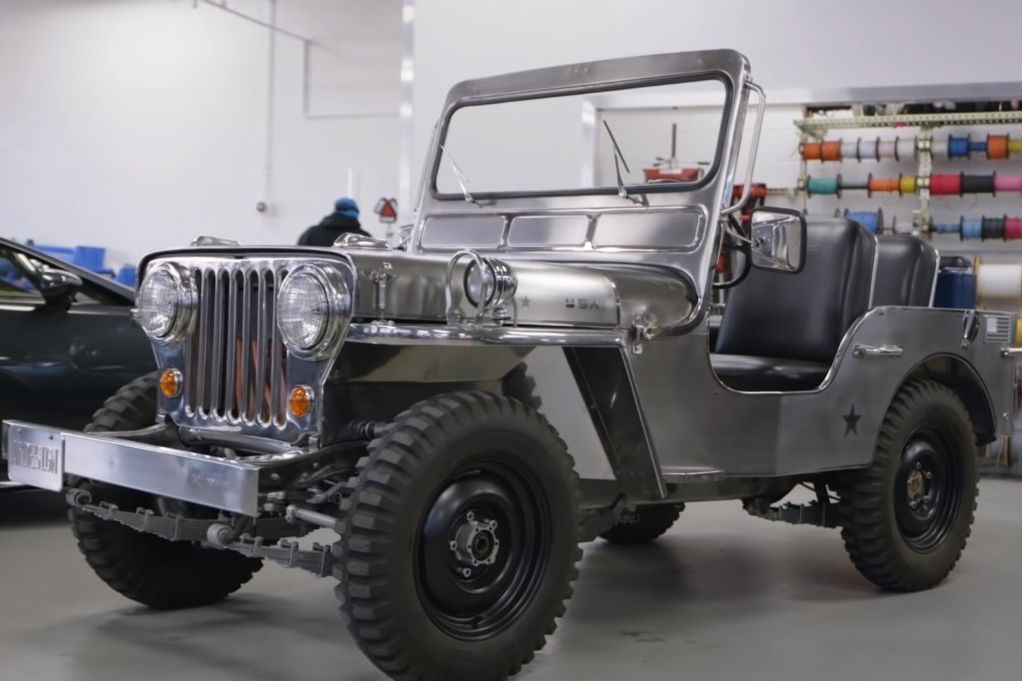 The EV converted Willys Jeep is outfitted with a historic stainless steel body.