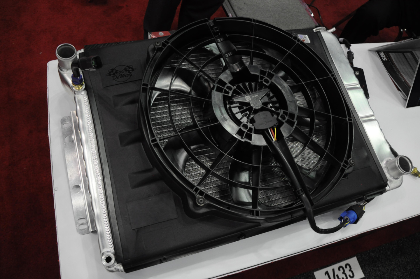 A SPAL brushless cooling fan sits affixed to a custom De Witts radiator for a C2 Corvette at PRI.