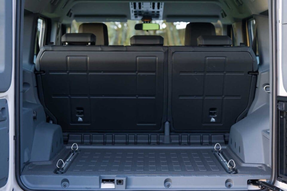 The rear cargo area is boxy, deep, and has integrated L-tracks to easily secure luggage. Photo: INEOS Automotive