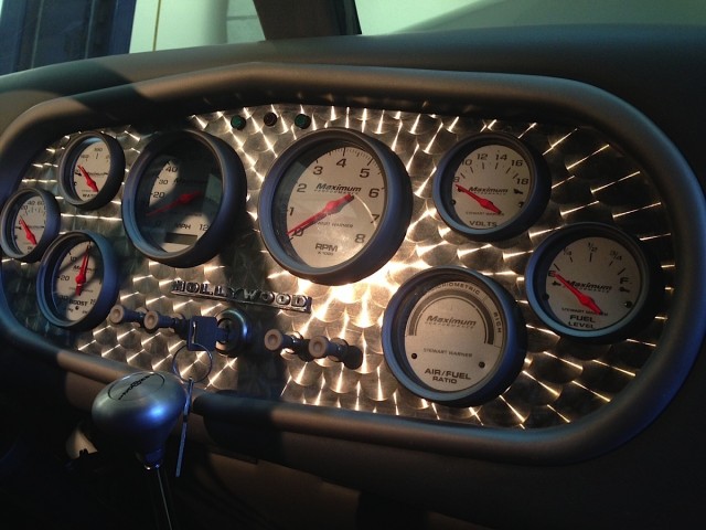 Inside, we see the new engine-turned dash with aftermarket gauges.