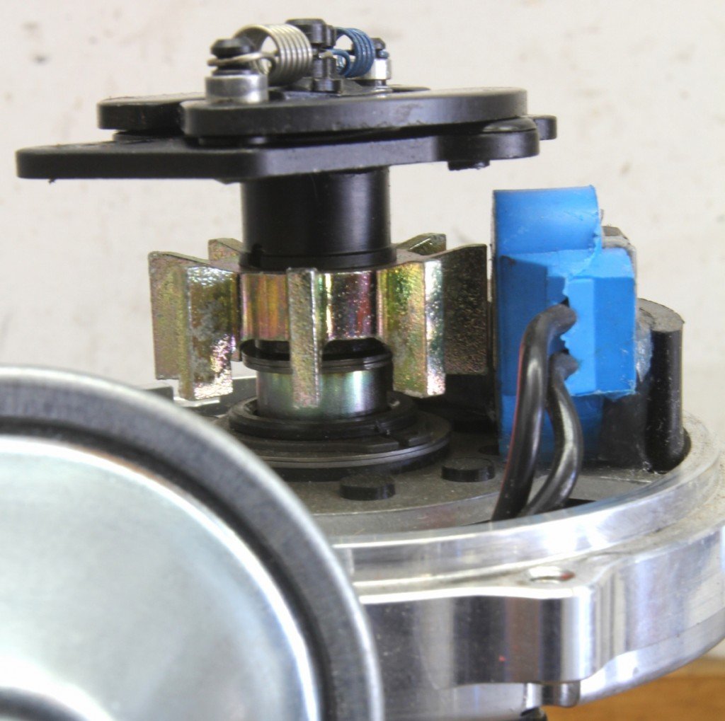 A magnetic pickup creates a signal when the rotating pole piece on the distributor shaft crosses the fixed magnet. This generates a tiny signal that triggers the coil — essentially an electronic version of a set of mechanical points, except no voltage passes through the pickup like it does with ignition points.